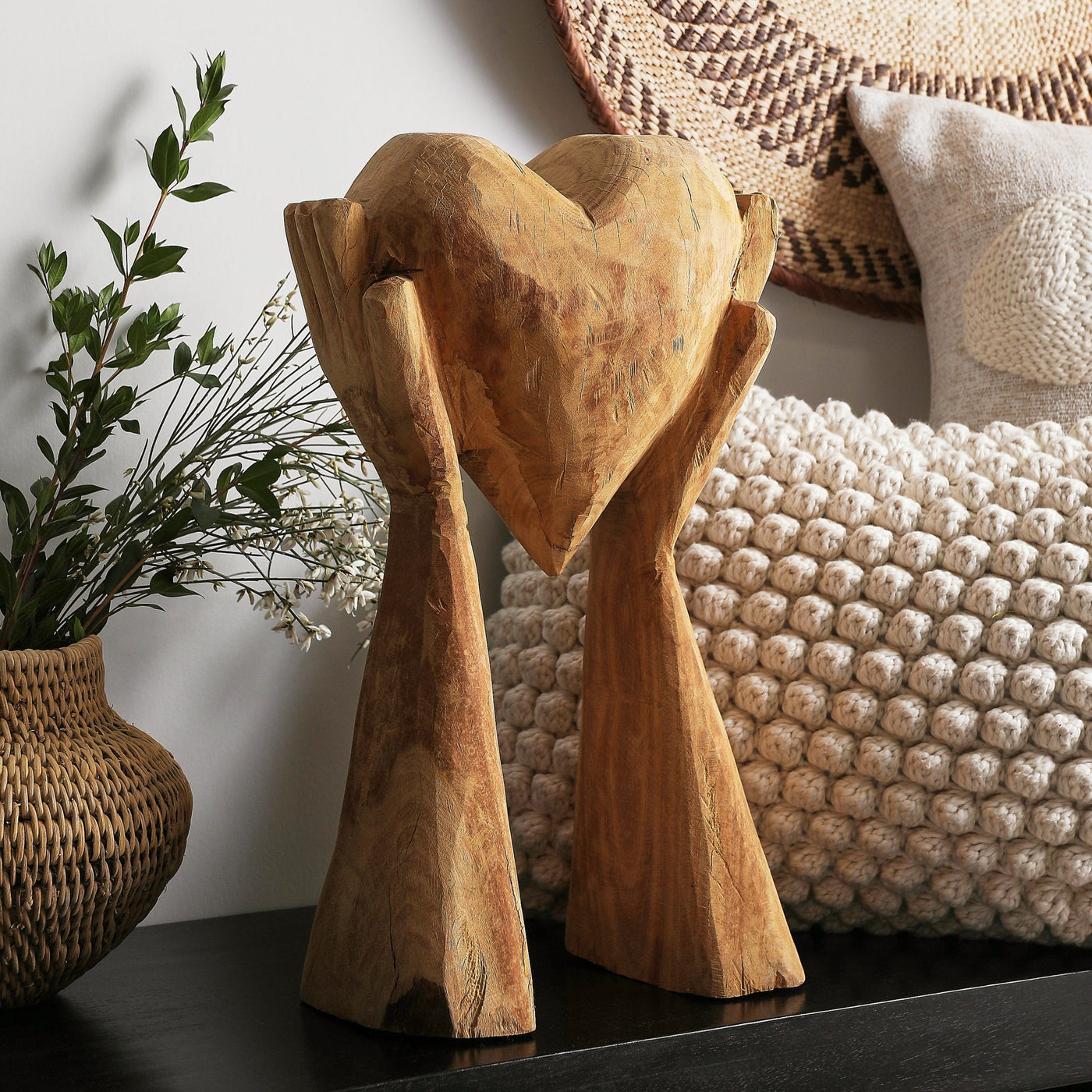 Hands Holding Heart Sculpture